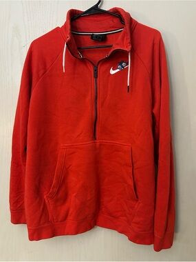 Nike women’s floral Swoosh quarter-zip sweatshirt in a vibrant red-orange color